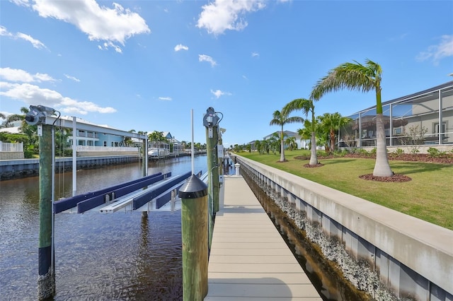 dock area with a yard, a water view, and a lanai