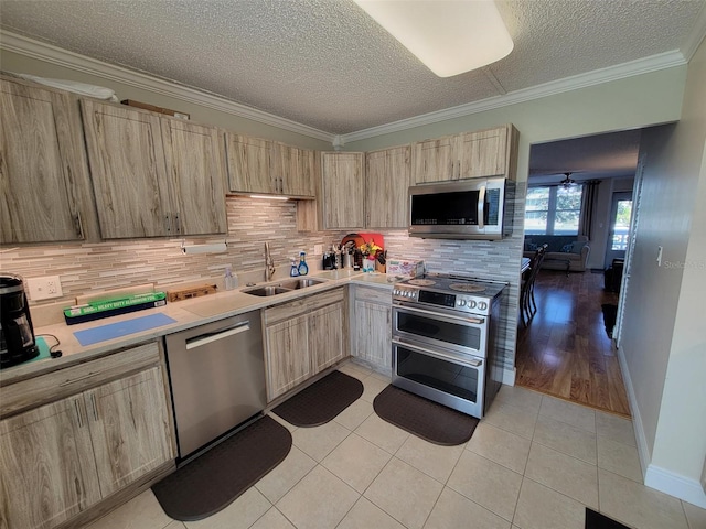 kitchen featuring crown molding, appliances with stainless steel finishes, sink, and light brown cabinets