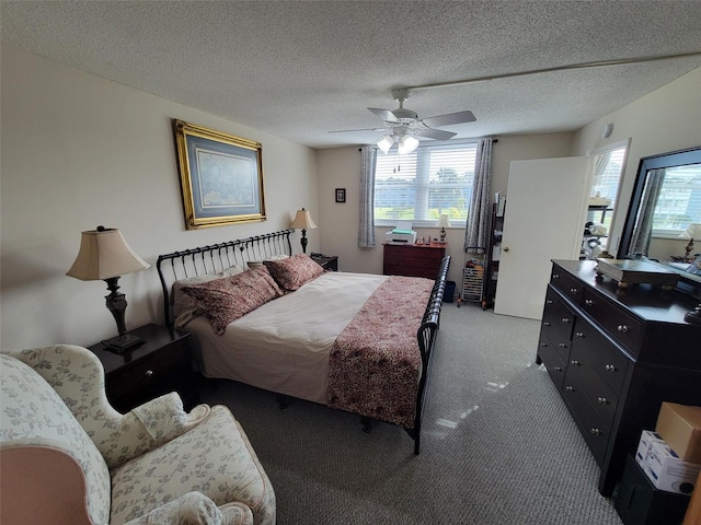 bedroom with a textured ceiling, carpet floors, and ceiling fan