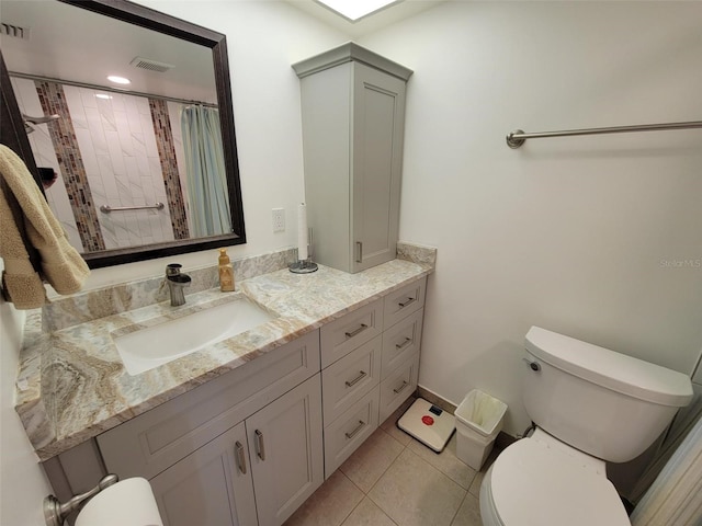 bathroom with vanity, toilet, a shower with curtain, and tile patterned flooring