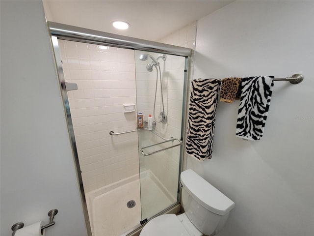 bathroom featuring toilet and walk in shower