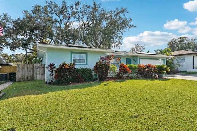 view of front facade with central AC, a front yard, and a garage