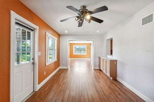 doorway featuring ceiling fan and hardwood / wood-style floors