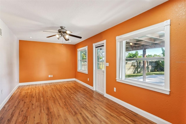 empty room with ceiling fan and light wood-type flooring