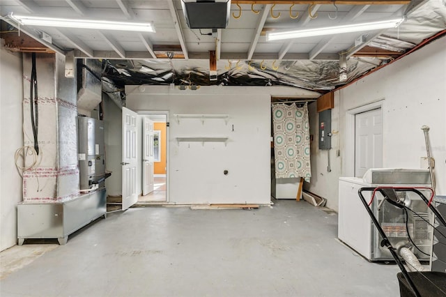 garage featuring electric panel and washer / clothes dryer