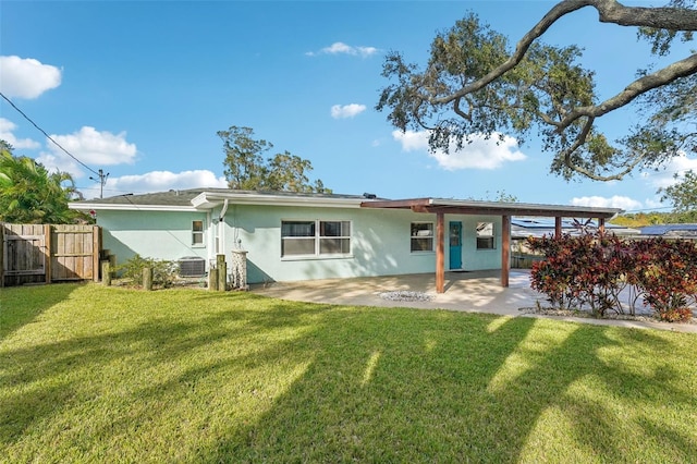 back of property with a yard, a patio, and central AC unit