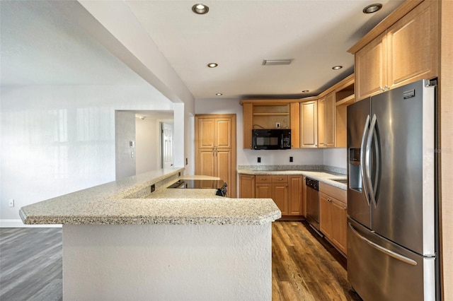 kitchen with stainless steel appliances, light stone counters, and dark wood-type flooring