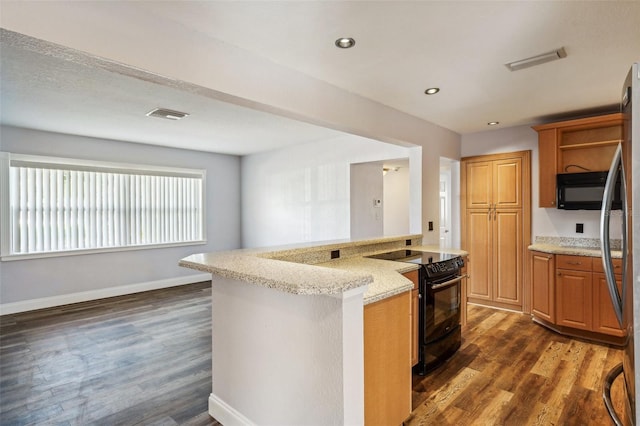 kitchen with light stone countertops, dark hardwood / wood-style floors, a kitchen island, and black appliances