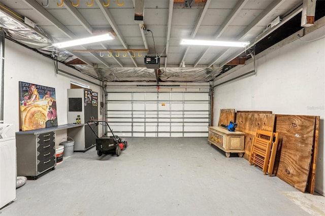 garage featuring washer / clothes dryer and a garage door opener