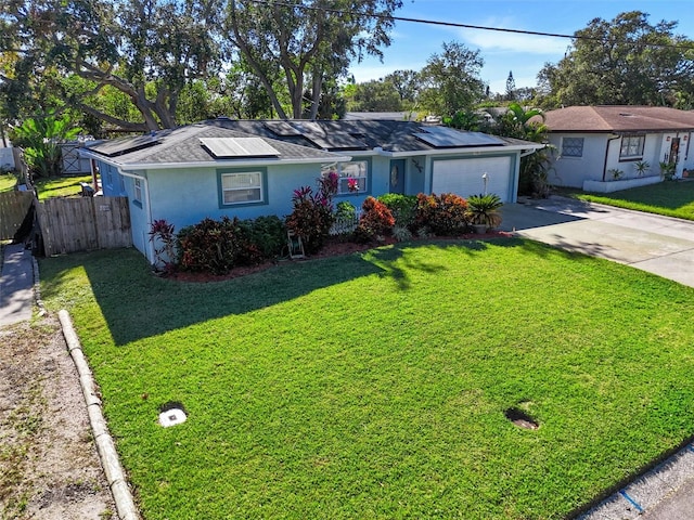 single story home featuring solar panels, a garage, and a front lawn