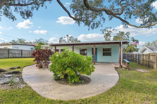 back of property featuring a lawn and a patio