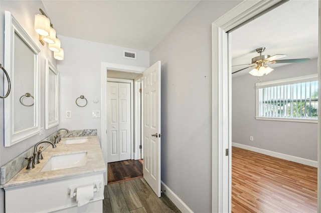 bathroom with hardwood / wood-style floors, vanity, and ceiling fan