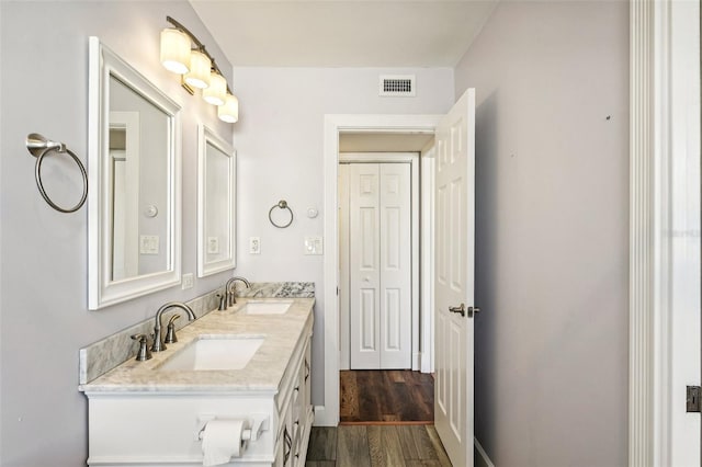 bathroom featuring vanity and wood-type flooring