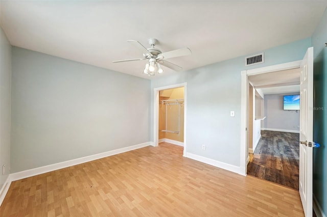 spare room featuring ceiling fan and light hardwood / wood-style floors