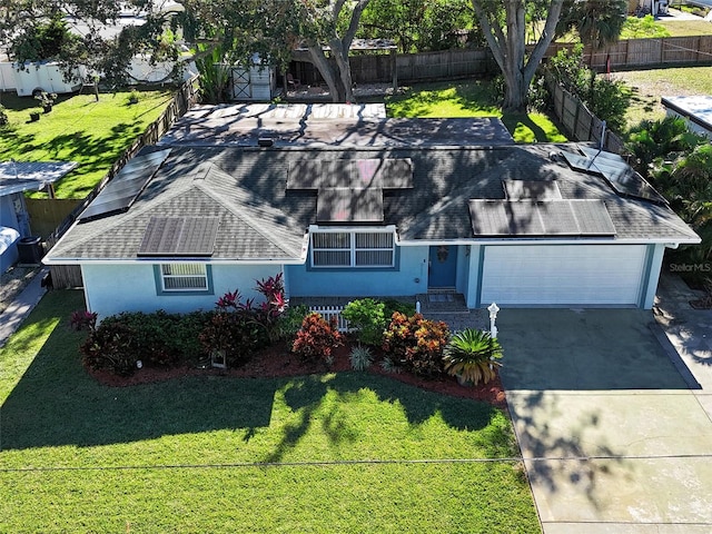 exterior space with solar panels, a garage, and a front yard