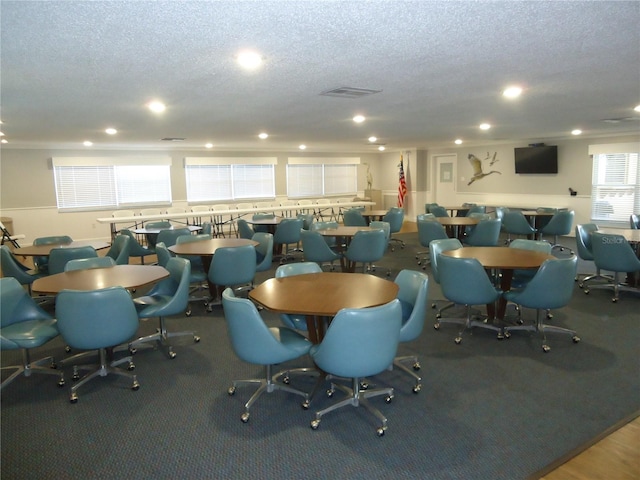 dining space with a textured ceiling and carpet floors