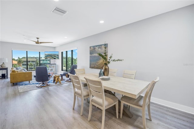 dining room with ceiling fan and light wood-type flooring