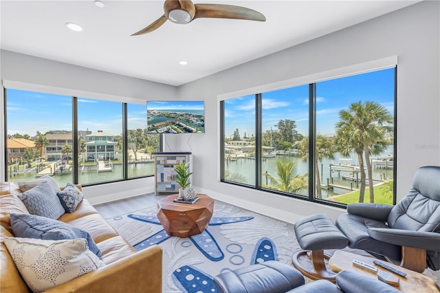 living room with hardwood / wood-style floors, a healthy amount of sunlight, and ceiling fan