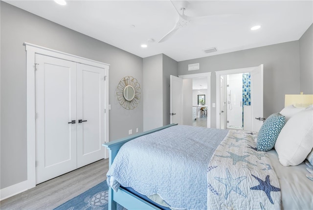 bedroom with light hardwood / wood-style floors, a closet, and ceiling fan