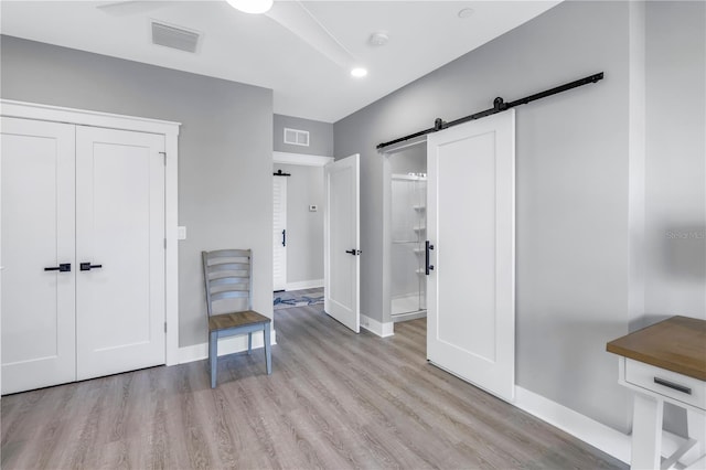 interior space featuring a barn door and light wood-type flooring