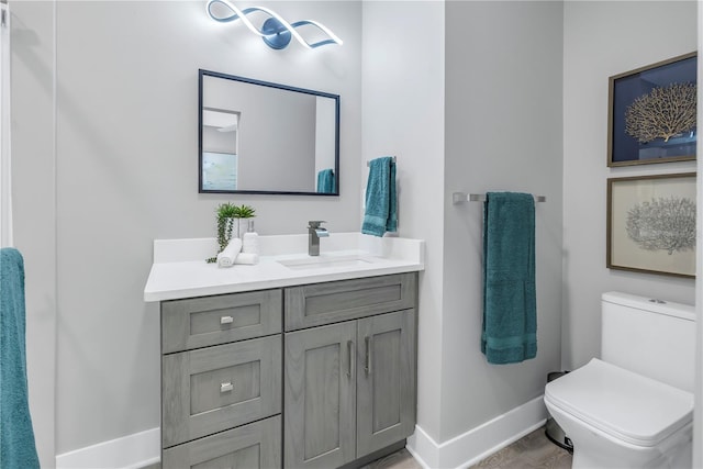 bathroom featuring vanity, toilet, and hardwood / wood-style flooring