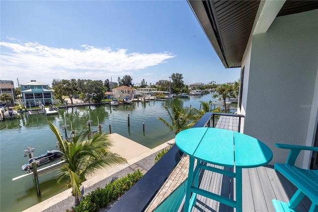 balcony with a water view and a boat dock