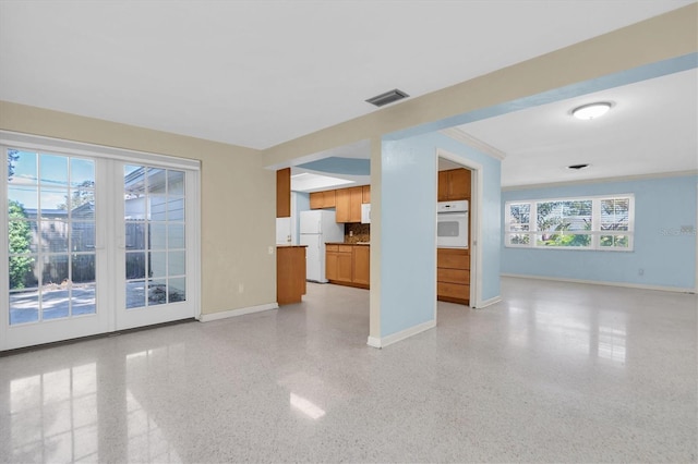 unfurnished living room featuring crown molding