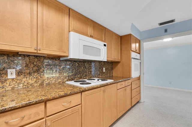 kitchen with tasteful backsplash, stone countertops, and white appliances