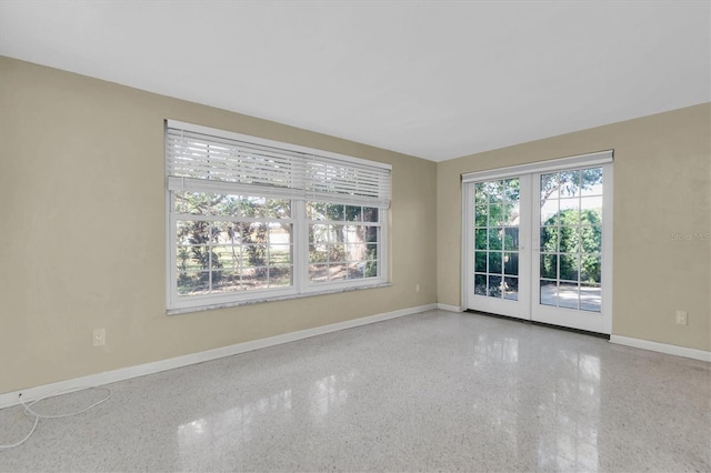 unfurnished room featuring french doors