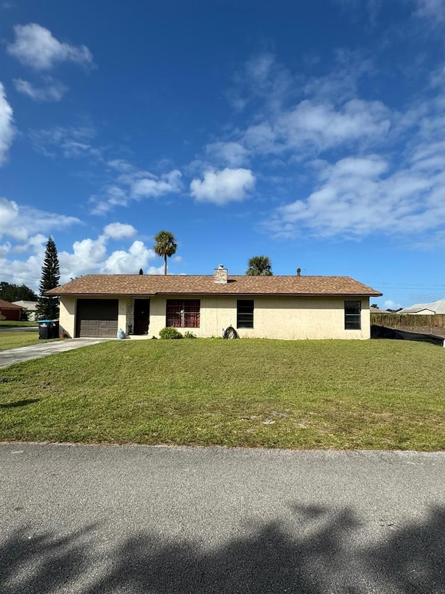 111 Carillo St NE, Palm Bay, FL 32907 - ranch-style house featuring a garage, driveway, stucco siding, and a front lawn