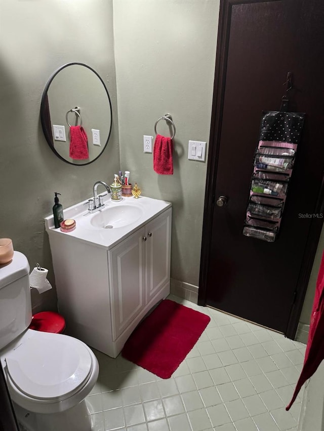 bathroom featuring vanity, toilet, and tile patterned flooring