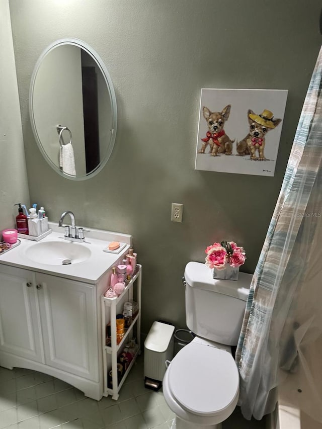 bathroom featuring vanity, a shower with curtain, toilet, and tile patterned floors