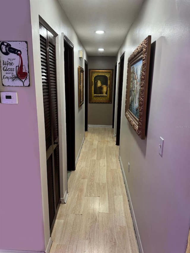 corridor with light hardwood / wood-style flooring