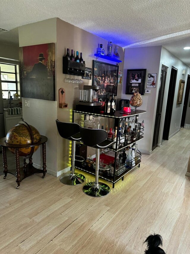 111 Carillo St NE, Palm Bay, FL 32907 - indoor dry bar with wood finished floors, a textured ceiling, and baseboards