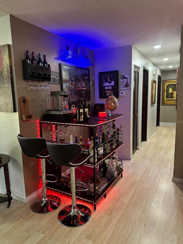 111 Carillo St NE, Palm Bay, FL 32907 - indoor dry bar with wood finished floors, a textured ceiling, and baseboards