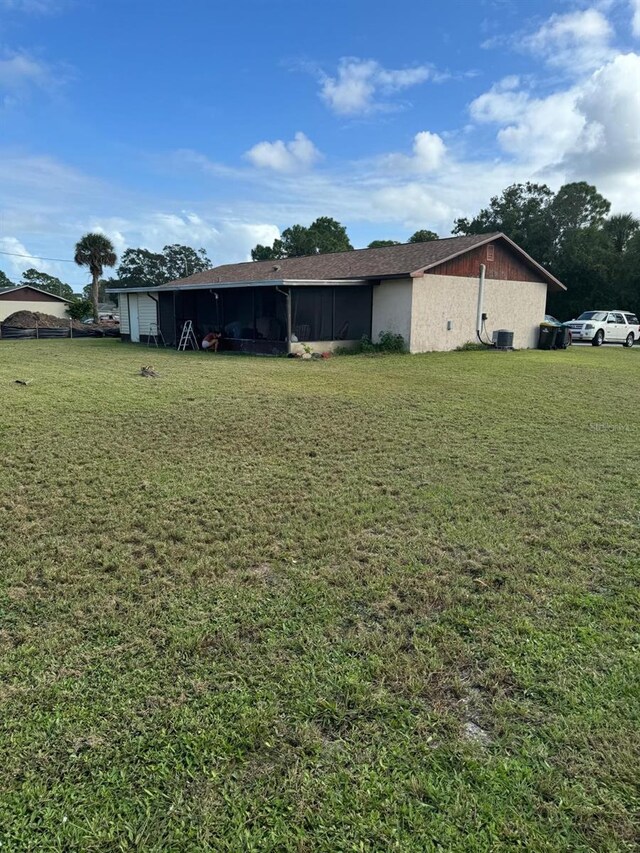 111 Carillo St NE, Palm Bay, FL 32907 - back of property with a yard, a carport, and a sunroom
