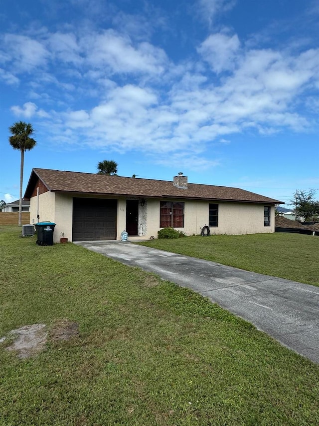 ranch-style home featuring a front yard, a garage, and cooling unit