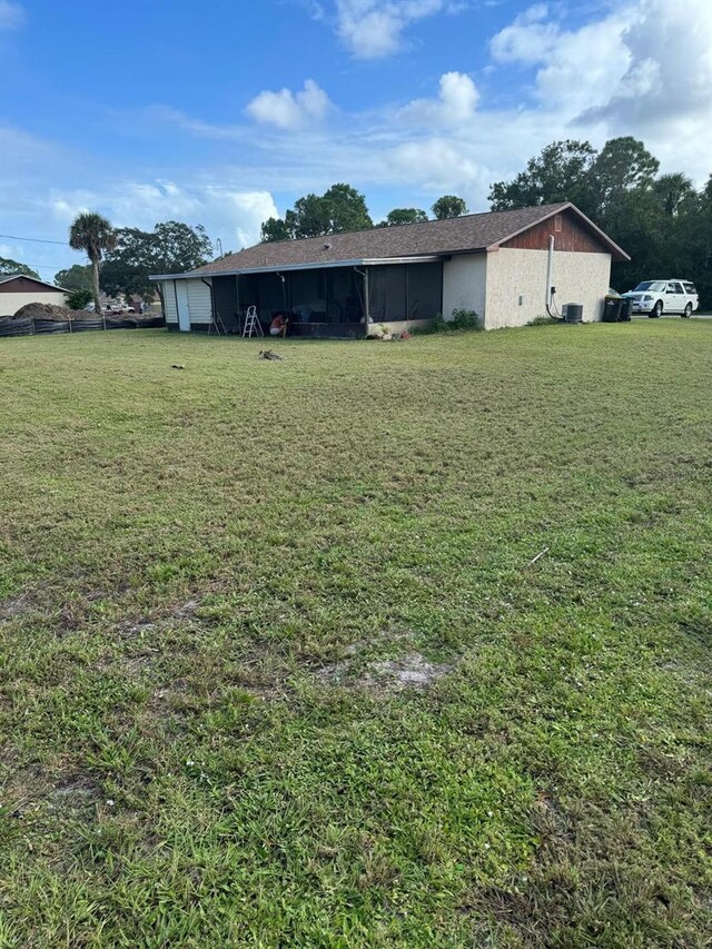 111 Carillo St NE, Palm Bay, FL 32907 - view of green lawn with a carport