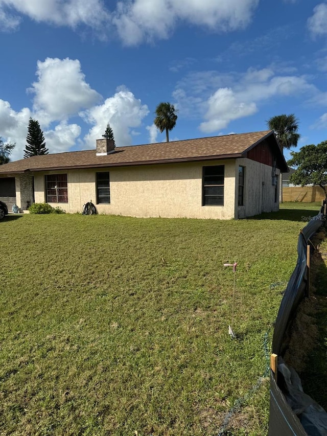 view of side of property with a lawn