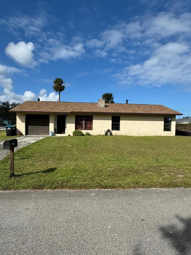 111 Carillo St NE, Palm Bay, FL 32907 - single story home featuring a garage, driveway, a front lawn, and stucco siding