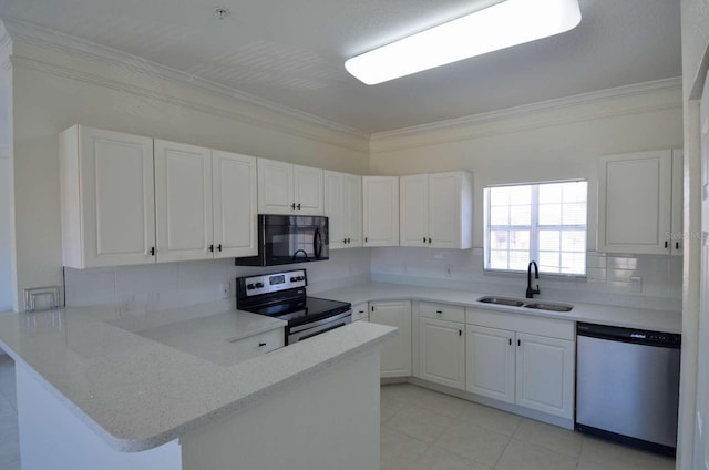 4336 Bayside Village Dr Unit 201, Tampa, FL 33615 - kitchen featuring appliances with stainless steel finishes, crown molding, a peninsula, backsplash, and white cabinets