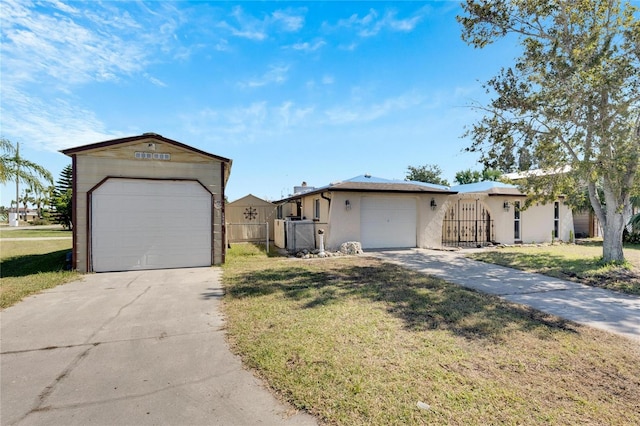 single story home featuring a garage and a front lawn