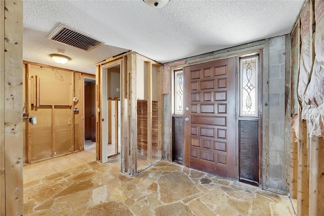 entryway featuring a textured ceiling