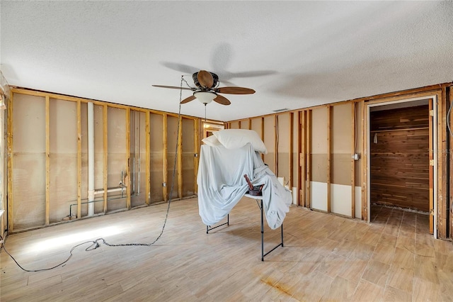 interior space featuring a textured ceiling and ceiling fan