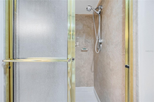 bathroom featuring a shower with shower door