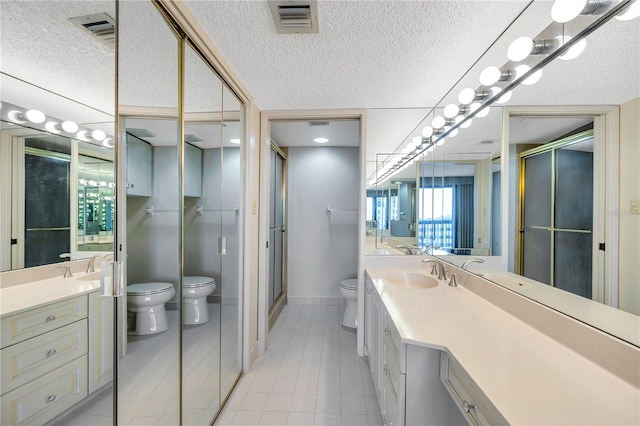 bathroom with vanity, toilet, a textured ceiling, and an enclosed shower