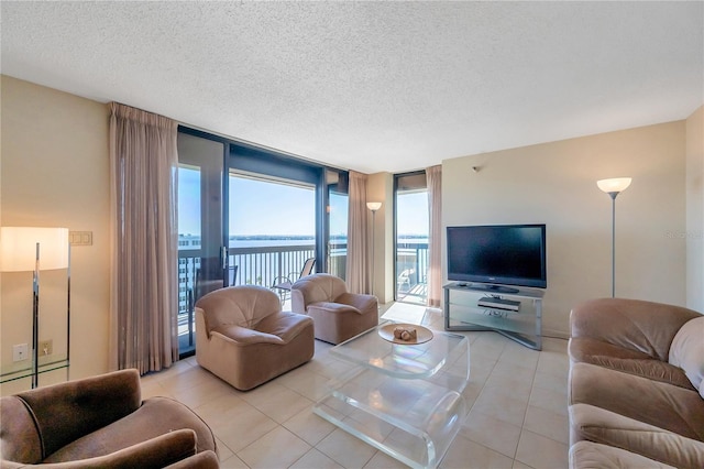 tiled living room with expansive windows and a textured ceiling