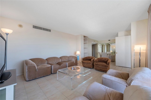 tiled living room with a textured ceiling