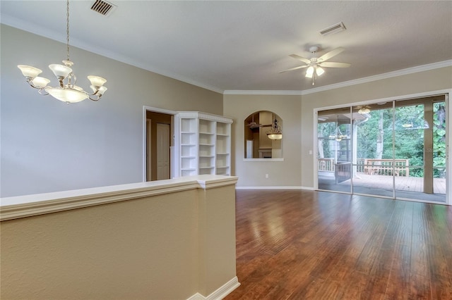 empty room with ornamental molding, dark hardwood / wood-style floors, and ceiling fan with notable chandelier