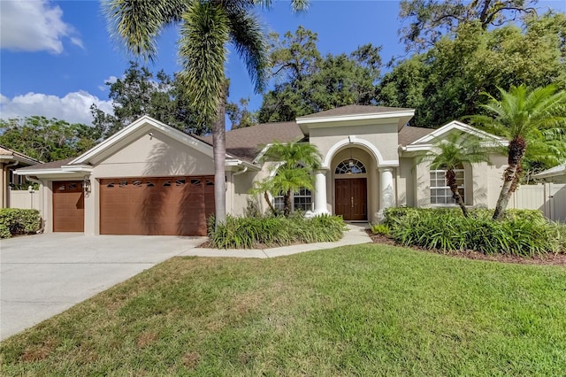 mediterranean / spanish-style house with a front yard and a garage